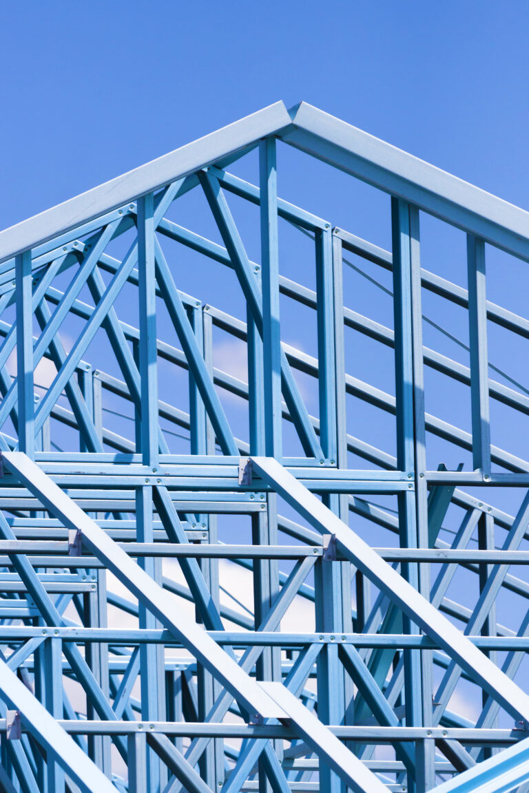 Closeup construction blue steel frame against blue sky, copy space