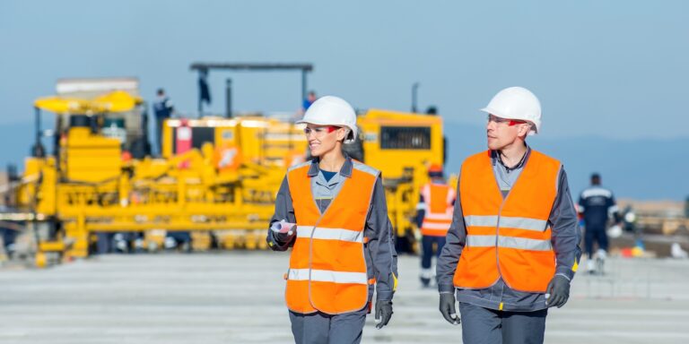 two workers blue sky airport runway plan